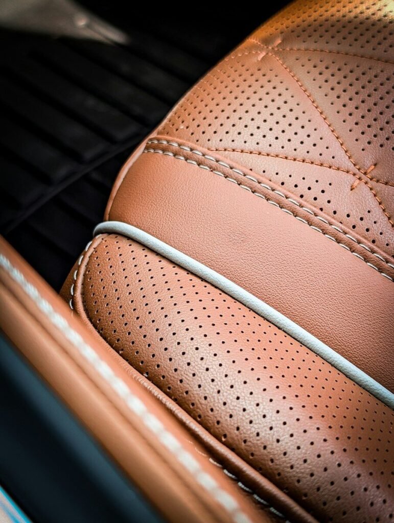 Close-up of a luxurious perforated brown leather car seat